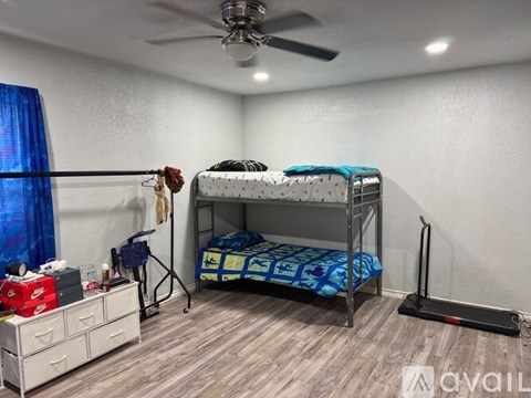 A bedroom with a bunk bed and a dresser.