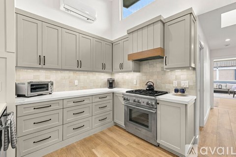 A kitchen with a stove top oven and a microwave.