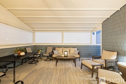 A sunny day in a spacious room with a long table and chairs.
