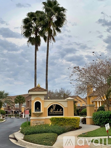 A sign for a place called "Mirabella" is in front of some trees.
