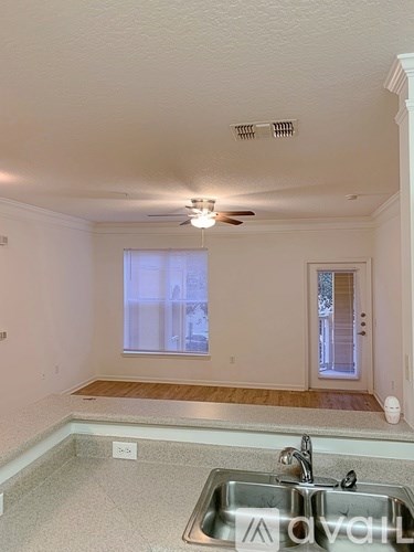 A kitchen with a sink and a window.