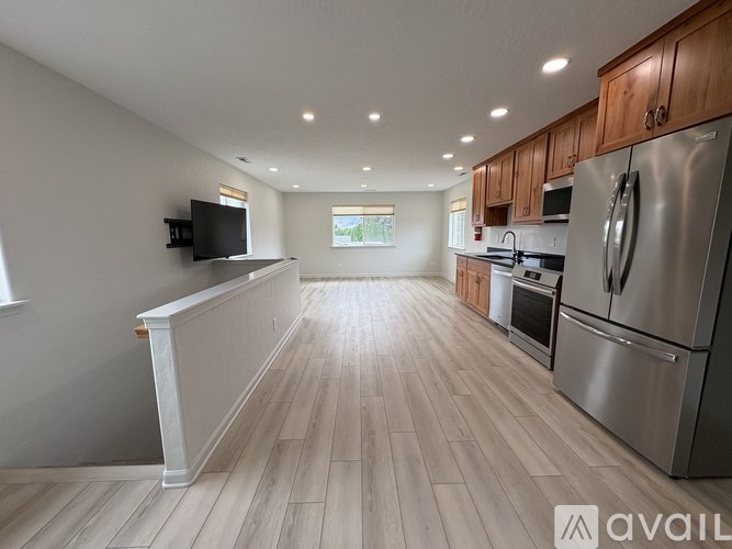 A kitchen with wooden cabinets and stainless steel appliances.