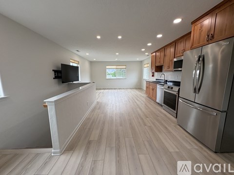 A kitchen with wooden cabinets and stainless steel appliances.