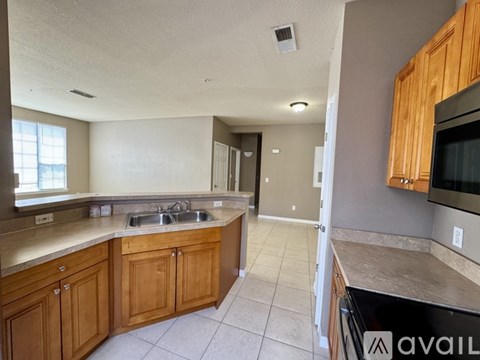 A kitchen with wooden cabinets and a black oven.