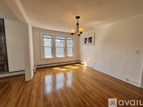 A room with wooden floors and a chandelier.