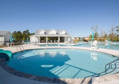 A large swimming pool with a building in the background.