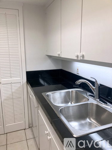 A kitchen with a sink and cabinets.