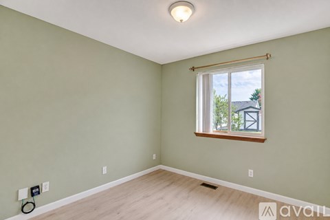 A room with a window and a white ceiling.