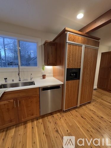 A kitchen with wooden cabinets and a sink.