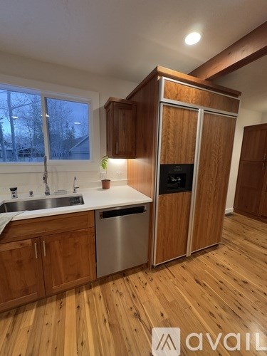 A kitchen with wooden cabinets and a sink.