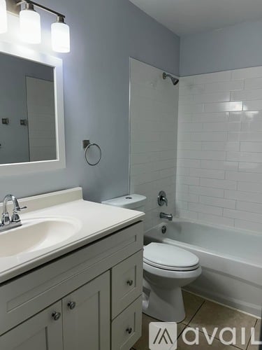 A bathroom with a white toilet and a white sink.