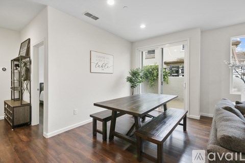 A dining room with a wooden table and bench.