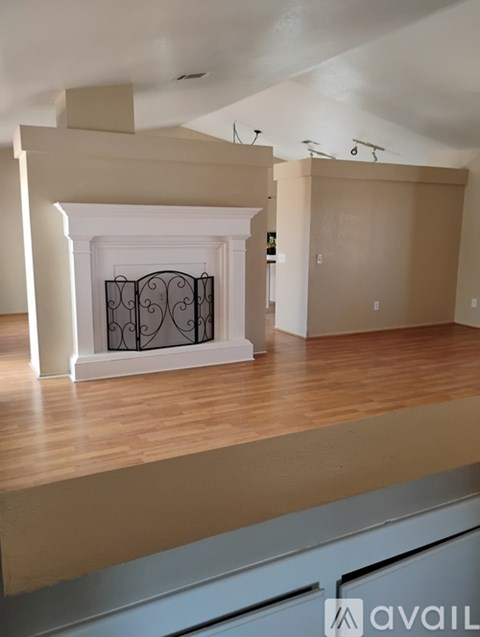 A room with a fireplace and wooden floors.
