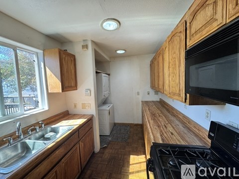 A kitchen with wooden cabinets and a black stove top.
