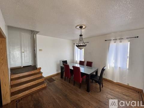 A dining room with a table set for four.