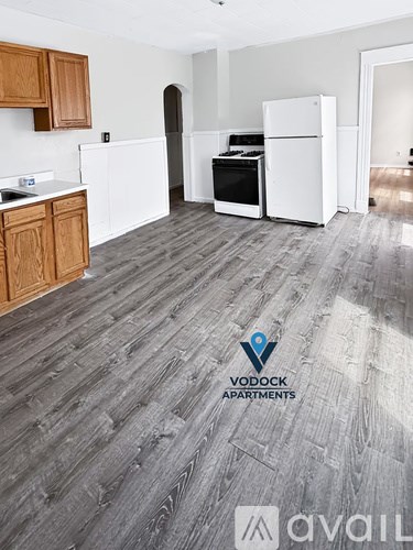 A Vodock Apartments sign is on a kitchen floor.