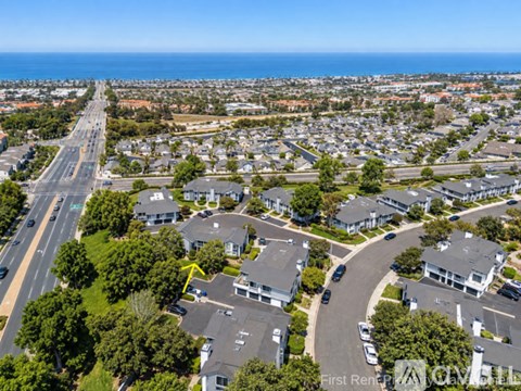 A bird's eye view of a residential area with houses and a road.