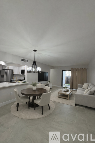 A modern dining room with a round table and chairs.