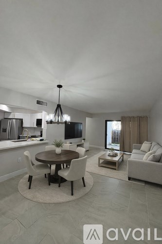 A modern dining room with a round table and chairs.