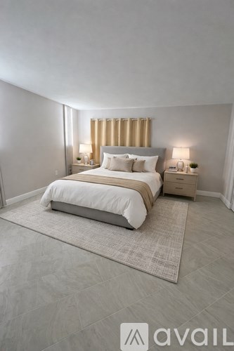 A bedroom with a large bed and two lamps on either side of the bed.