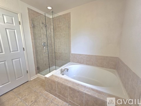 A bathroom with a tub and a walk-in shower.