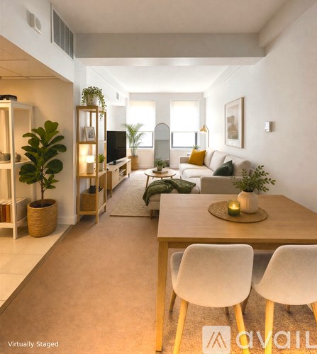 A living room with a wooden table and white chairs.