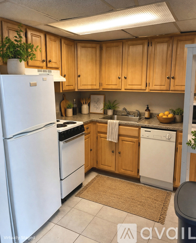 A kitchen with wooden cabinets and white appliances.