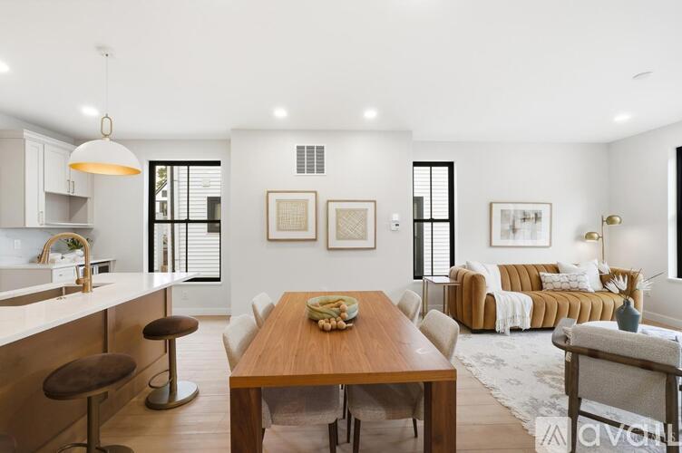 A modern kitchen with a dining table and chairs.