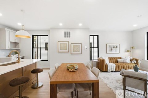A modern kitchen with a dining table and chairs.