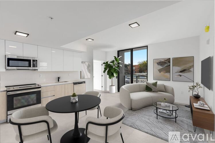 A modern living room with a black table and white furniture.