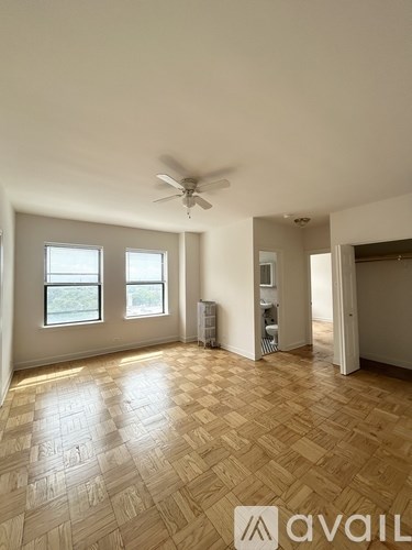 A room with wooden flooring and a ceiling fan.