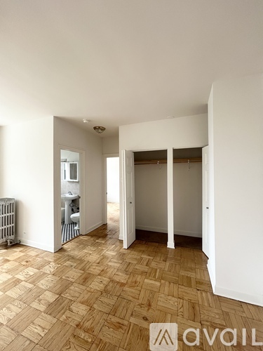 A room with a wooden floor and white walls.