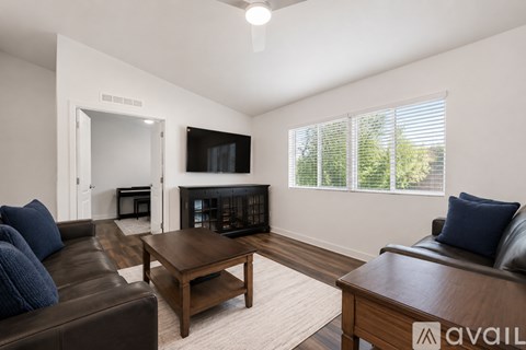 A living room with a fireplace and a television.