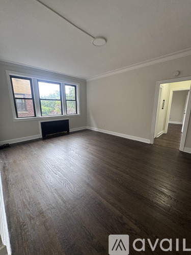 A room with wood flooring and a window.