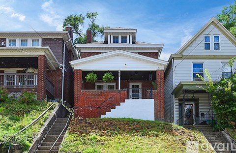 A house with a red brick wall and a white door.