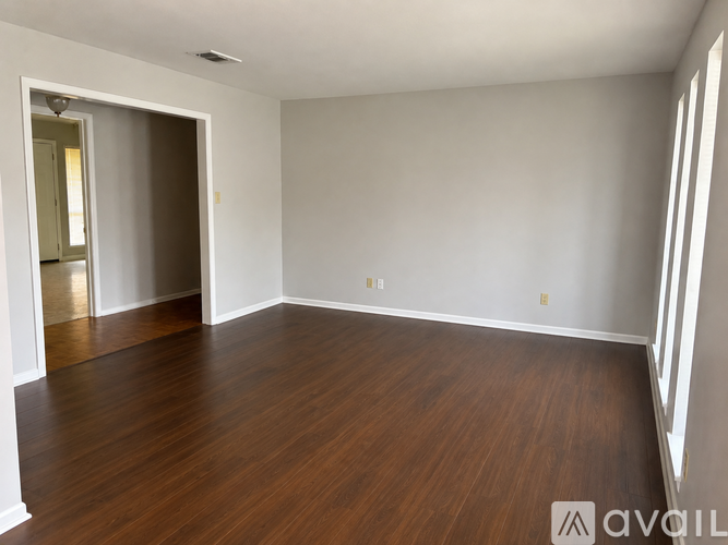 A room with wooden floors and white walls.