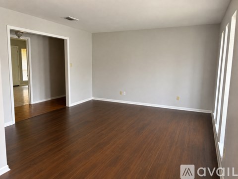 A room with wooden floors and white walls.