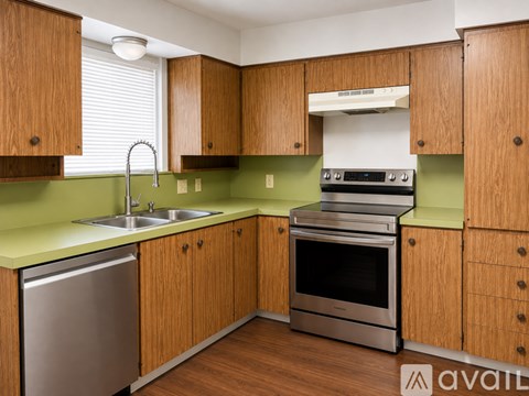 A kitchen with wooden cabinets and a green countertop.