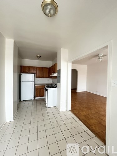 A kitchen with white appliances and brown cabinets.