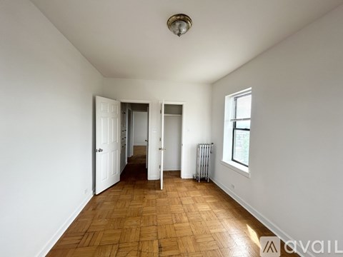 A room with wooden flooring and white walls.