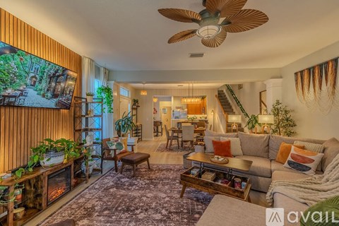 A living room with a grey couch and a wooden coffee table.