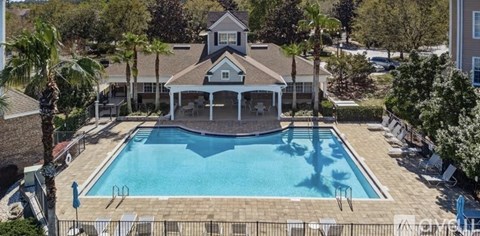 A pool with a gazebo in the middle of it.