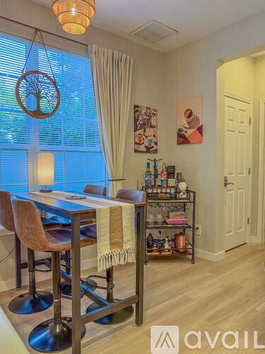 A dining area with a table and chairs.