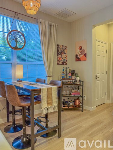 A dining area with a table and chairs.