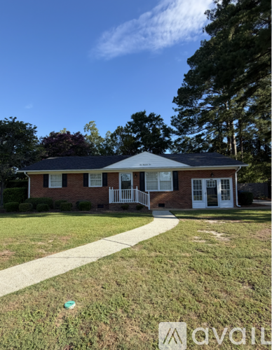 A house with a white picket fence is for sale.
