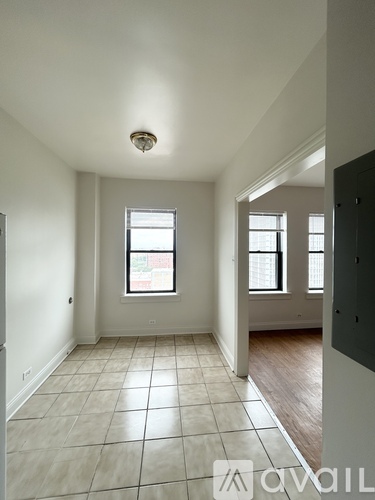 A room with a window and tiled flooring.