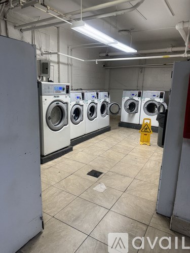 A row of washing machines in a laundry room.