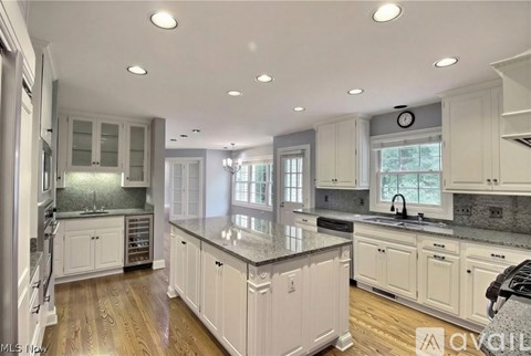 A modern kitchen with white cabinets and a large island.