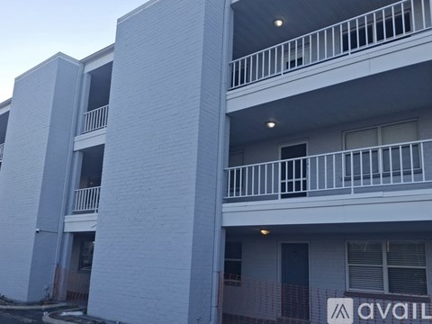Apartment building with a sign that says "AVAILABLE".