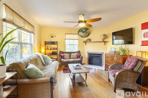 A living room with a sofa, armchair, and coffee table.